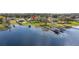 Aerial view of lakefront home with private boat dock and lift at 10919 Lakeshore Dr, Clermont, FL 34711