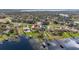 Beautiful lakefront property showcasing the home, expansive yard, and private boat dock at 10919 Lakeshore Dr, Clermont, FL 34711