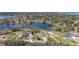 Aerial view of lakefront homes featuring private boat docks, boat lifts, and community amenities at 10919 Lakeshore Dr, Clermont, FL 34711