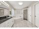 Bright bathroom featuring a soaking tub, glass shower, and granite countertop with white cabinets at 10919 Lakeshore Dr, Clermont, FL 34711