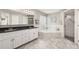 Bright bathroom featuring a soaking tub, glass shower, and granite countertop with white cabinets at 10919 Lakeshore Dr, Clermont, FL 34711