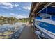 Covered boat dock and boat lift offering a relaxing lakeside experience at 10919 Lakeshore Dr, Clermont, FL 34711