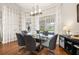 Bay window offers views from this dining area with modern table and chairs at 10919 Lakeshore Dr, Clermont, FL 34711