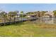 Dock with boat covers and scenic lakefront views on a beautiful day at 10919 Lakeshore Dr, Clermont, FL 34711