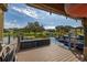 Dockside view of covered personal watercraft and tranquil lake on a sunny day at 10919 Lakeshore Dr, Clermont, FL 34711