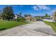 Well-kept circular driveway leads to this wonderful home, complete with verdant lawn at 10919 Lakeshore Dr, Clermont, FL 34711