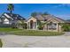 Beautiful single-story home with manicured lawn, circular driveway, and grand entrance at 10919 Lakeshore Dr, Clermont, FL 34711