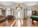 Bright foyer features a soaring ceiling, hardwood floors, and an elegant front door with decorative sidelights at 10919 Lakeshore Dr, Clermont, FL 34711