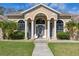 Beautiful front entrance with an arched glass door and white pillars on either side at 10919 Lakeshore Dr, Clermont, FL 34711