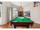 Bright and sunny game room with billiard table and hardwood floors at 10919 Lakeshore Dr, Clermont, FL 34711