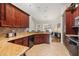 Spacious eat-in kitchen with granite countertops, wood cabinets and a large window at 10919 Lakeshore Dr, Clermont, FL 34711