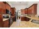 Modern kitchen with granite countertops, stainless steel appliances, and dark wood cabinets at 10919 Lakeshore Dr, Clermont, FL 34711