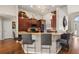 Well-lit kitchen featuring breakfast bar, ample wood cabinetry, and stainless appliances at 10919 Lakeshore Dr, Clermont, FL 34711