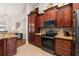 Cozy kitchen featuring stainless steel appliances, wood cabinetry, and tile flooring at 10919 Lakeshore Dr, Clermont, FL 34711