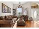 Cozy living room featuring hardwood floors, comfortable seating, and lots of natural light at 10919 Lakeshore Dr, Clermont, FL 34711