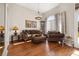 Cozy living room featuring hardwood floors, comfortable seating, and lots of natural light at 10919 Lakeshore Dr, Clermont, FL 34711