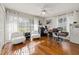 Sun-lit office space featuring hardwood floors, a ceiling fan, and large bright windows at 10919 Lakeshore Dr, Clermont, FL 34711