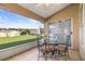 Screened patio with dining table offers an outdoor entertaining space overlooking the yard at 10919 Lakeshore Dr, Clermont, FL 34711