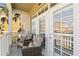 Charming balcony with cozy armchairs and a view of the property's exterior at 1221 Olmstead Blvd # 214, Celebration, FL 34747