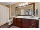 Bathroom featuring hardwood floors, decorative mirror, and vanity with storage at 1221 Olmstead Blvd # 214, Celebration, FL 34747