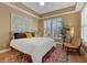 Bright bedroom with natural lighting, colorful rug and decor at 1221 Olmstead Blvd # 214, Celebration, FL 34747