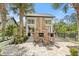 Outdoor stone fireplace with rocking chairs on a stone patio and nice landscaping at 1221 Olmstead Blvd # 214, Celebration, FL 34747