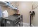 Well-equipped laundry room with modern, front-loading washer and dryer, and ample storage shelves at 1221 Olmstead Blvd # 214, Celebration, FL 34747