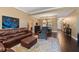 Inviting living room with a plush leather sofa, elegant rug, and hardwood floors at 1221 Olmstead Blvd # 214, Celebration, FL 34747