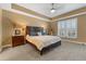 Main bedroom with tray ceiling, plantation shutters, and neutral color palette at 1221 Olmstead Blvd # 214, Celebration, FL 34747