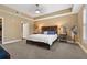 Spacious main bedroom featuring tray ceiling, plush carpet, and walk-in closet at 1221 Olmstead Blvd # 214, Celebration, FL 34747