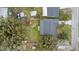 An aerial view of a home with a large backyard, sheds, and is surrounded by trees at 1506 Maryland Ave, St Cloud, FL 34769