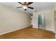 Spacious bedroom with hardwood floors that leads to an ensuite bathroom with a glass shower at 1506 Maryland Ave, St Cloud, FL 34769