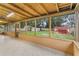 Enclosed sunroom has tile floor with plenty of natural light and view of sheds in backyard at 1506 Maryland Ave, St Cloud, FL 34769