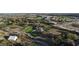 A captivating aerial view of the property enclosed by fencing and bordered by lush greenery and a serene road at 15350 Arabian Way, Montverde, FL 34756