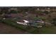 An aerial view of a fenced property featuring a pool, RV parking, a mini golf area, and a soccer field at 15350 Arabian Way, Montverde, FL 34756