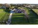 Aerial view of a home with a large lawn and a driveway leading up to the house at 15350 Arabian Way, Montverde, FL 34756