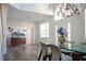 Bright dining room with a glass-top table and a decorative bar with hardwood floors at 15350 Arabian Way, Montverde, FL 34756