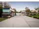 Long concrete driveway leading to a garage and carport, with a luxury RV parked alongside at 15350 Arabian Way, Montverde, FL 34756