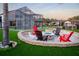 Fire pit area with colorful Adirondack chairs and a screened lanai overlooking the pool at 15350 Arabian Way, Montverde, FL 34756