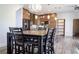 Open kitchen and dining area with custom cabinetry, stainless steel appliances, and modern fixtures at 15350 Arabian Way, Montverde, FL 34756