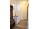 Mudroom with stainless steel sink, open shelving, storage bench, and modern barn door at 15350 Arabian Way, Montverde, FL 34756