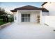 Covered patio with white tile flooring, offering a serene and private outdoor space at 15350 Arabian Way, Montverde, FL 34756