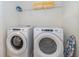 Clean laundry room with white washer, dryer and white wire rack at 1696 Tropical Palms Cir, Kissimmee, FL 34747