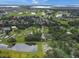 Aerial view of a neighborhood with ponds, lush trees, and residences with well-manicured lawns at 1710 Big Oak Ln, Kissimmee, FL 34746