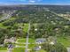 Aerial view of the neighborhood showcasing lush trees, well-manicured lawns, and nearby roads at 1710 Big Oak Ln, Kissimmee, FL 34746