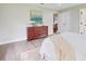 Bright bedroom with hardwood floors, and wooden dresser at 1710 Big Oak Ln, Kissimmee, FL 34746