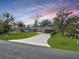 Charming one-story home with neatly manicured lawn and driveway leading up to the two-car garage at 1710 Big Oak Ln, Kissimmee, FL 34746