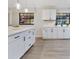 Bright and airy kitchen featuring white cabinets, a large island, and modern pendant lighting at 1710 Big Oak Ln, Kissimmee, FL 34746