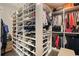 Spacious walk-in closet featuring custom shelving and hanging rods for optimal storage at 1894 Valley Forge Dr, St Cloud, FL 34769