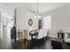 Elegant dining area featuring dark wood floors, a modern light fixture, and seating for six at 1894 Valley Forge Dr, St Cloud, FL 34769